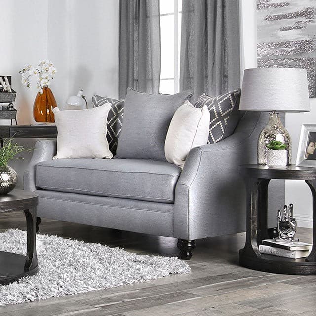 Nefyn Gray Transitional Loveseat in a stylish living room with decorative pillows and stylish furniture accents.