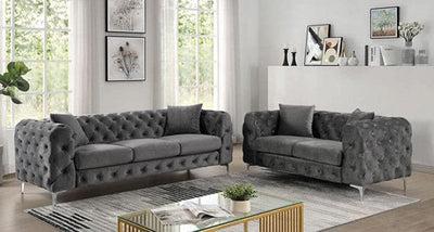 Contemporary dark gray sofas with tufted arms in a bright living room setting.