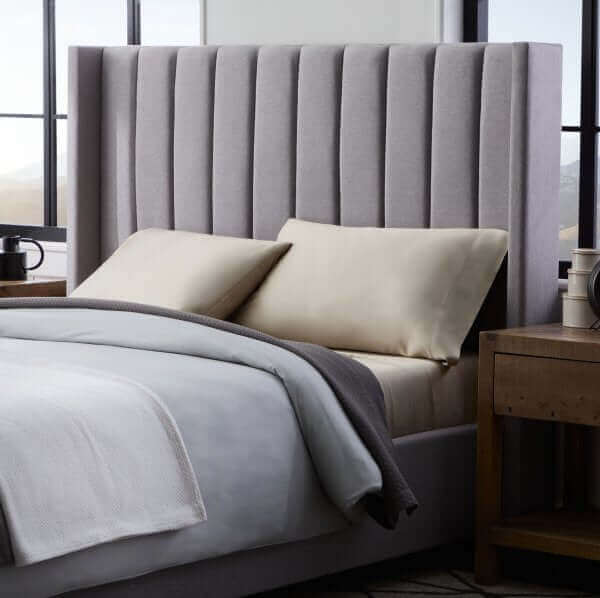 Malouf Blackwell Stone Headboard featuring sophisticated padded design and plush vertical channels in a modern bedroom setting.