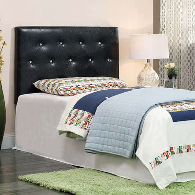 Twin Velen Black Leatherette Headboard with acrylic buttons, stylishly complementing a bed with colorful bedding.