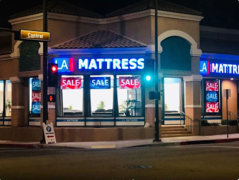 Glendale LA Mattress Store with illuminated signage and parking area at night