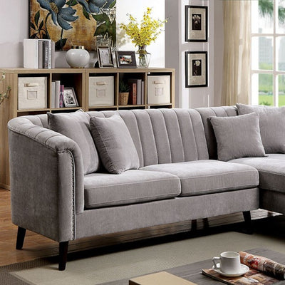 Goodwick Gray Sectional Sofa with button tufted back and plush cushions in stylish living room setting.