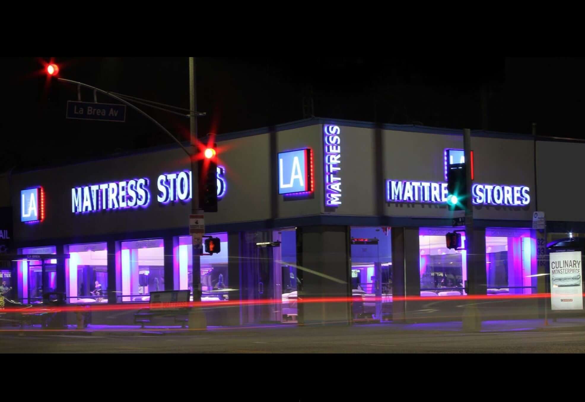 Hancock Park LA Mattress Store on La Brea Avenue with bright exterior at night