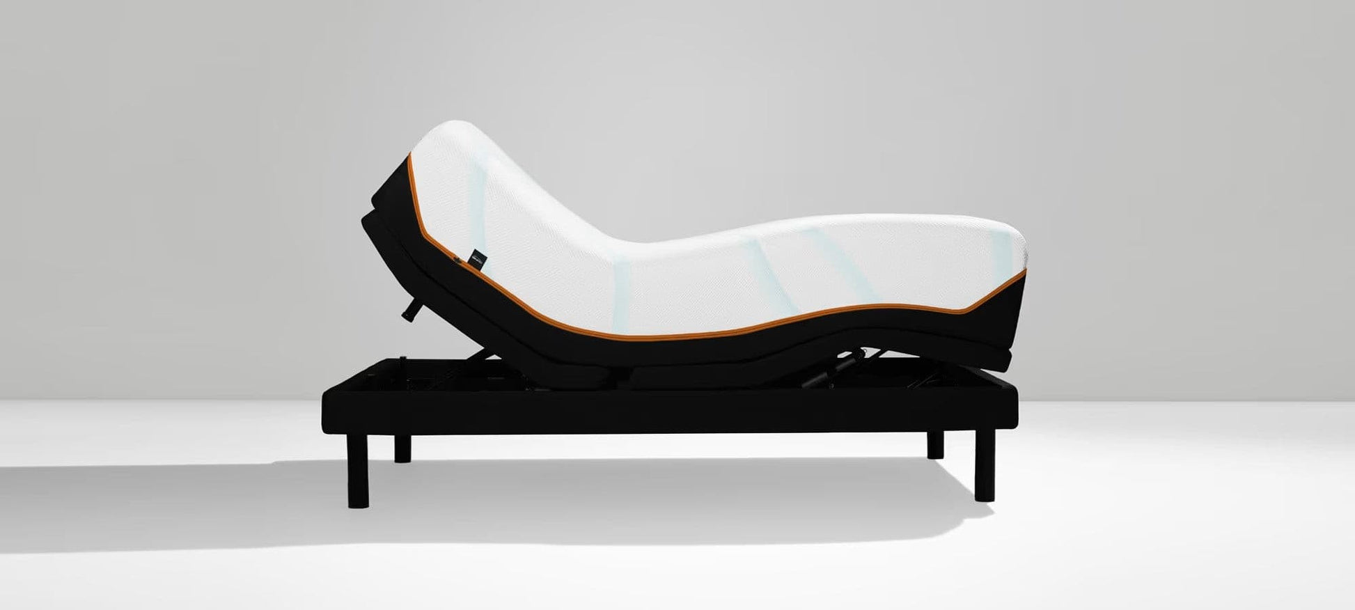 Twin XL Tempur-Pedic TEMPUR-LuxeAdapt® mattress in adjustable position on a sleek base.