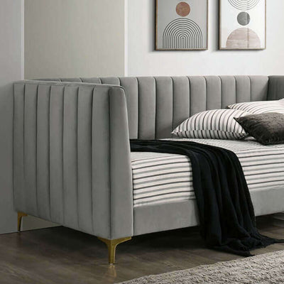 Neoma light gray daybed with tuxedo-inspired design and gold metal legs, showcasing elegant upholstery and comfort.