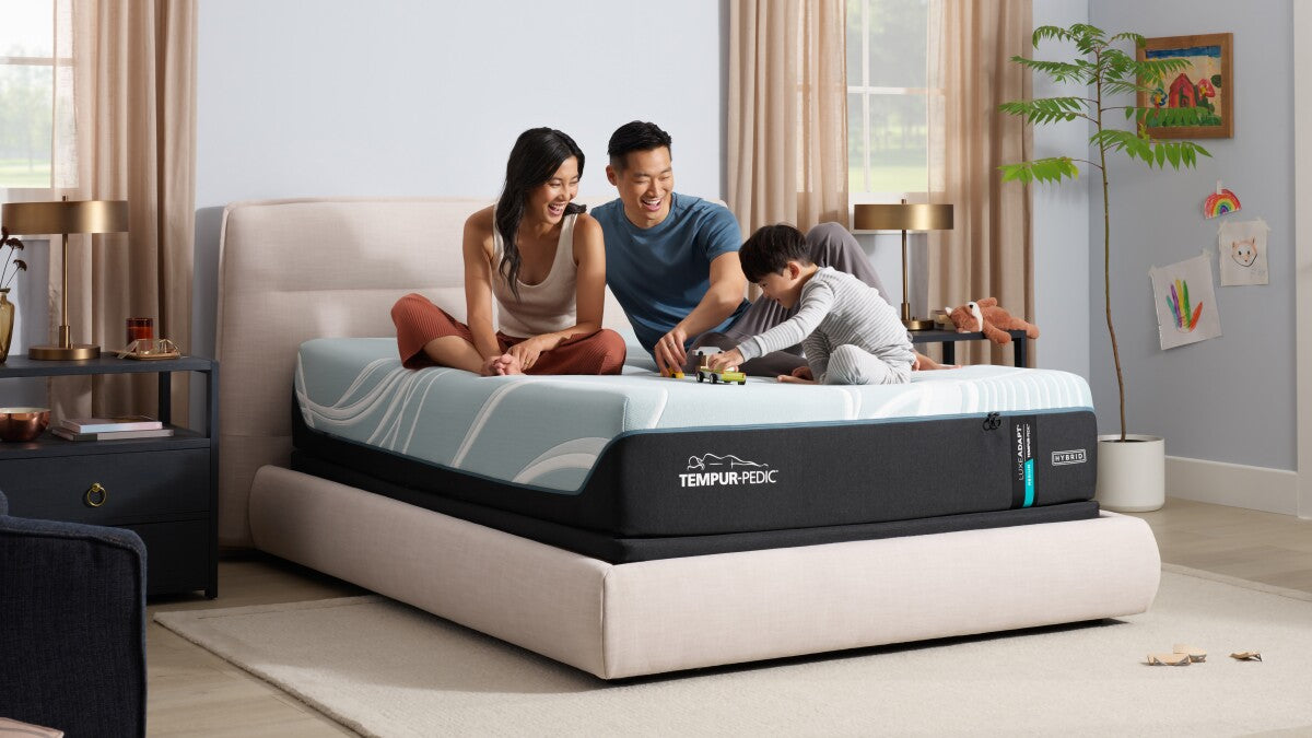 Family enjoying quality time on the Tempur-Pedic TEMPUR-Adapt 11" Medium Hybrid Mattress in a cozy bedroom setting.