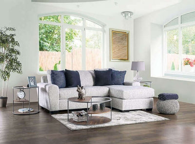 Eastcote Gray Sectional Sofa in stylish living room with natural light, featuring accent pillows and chic decor elements.