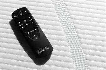 Tempur-Pedic remote control on mattress, designed for TEMPUR-Extend Power Adjustable Base for custom comfort.