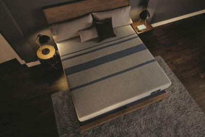 Top view of CA King Serta iComfort Blue Max Touch 3000 Plush 14" Foam mattress on a wooden bed frame in a stylish bedroom setting.