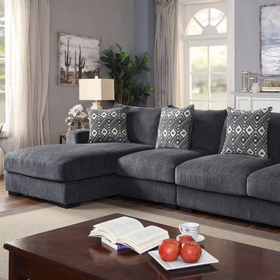 Cozy Kaylee Gray sectional sofa with patterned pillows in a bright living room setting, perfect for relaxation.