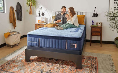 Couple enjoying comfort on the Stearns & Foster 14.5" Hybrid Plush Mattress in a stylish bedroom setting.
