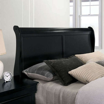 Sleigh bed design featuring a Louis Philippe black slate headboard and plush bedding in a stylish bedroom setting.