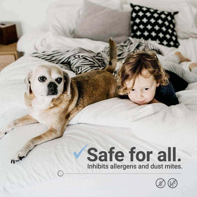 Child and dog on a mattress, showcasing a hypoallergenic protector that inhibits allergens and dust mites.