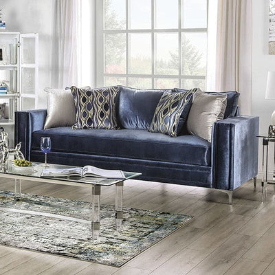 Contemporary blue satin sofa with decorative pillows in a bright living room setting, featuring chrome legs and track arms.