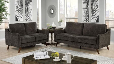 Maxime Dark Gray Loveseat in a modern living room with tapered legs and stylish decor elements.