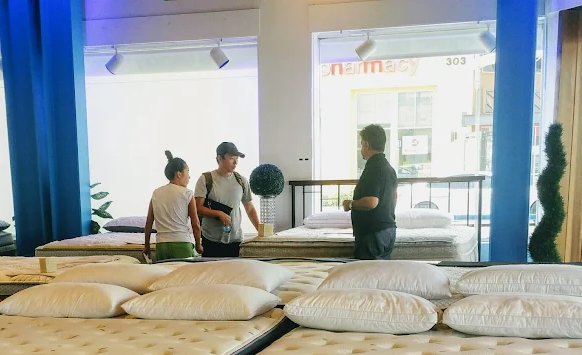 Julio helping customers find the right mattress at LA Mattress Store on La Brea