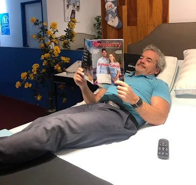 Wayne demonstrating an adjustable bed at LA Mattress Studio City showroom